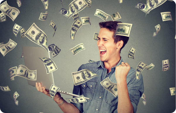 Man using a tablet with dollar bills falling around him
